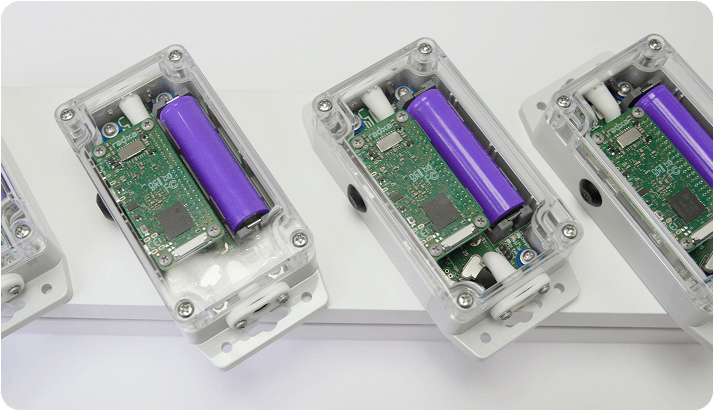 Compact V2M-One devices in transparent enclosures with circuit boards and purple batteries